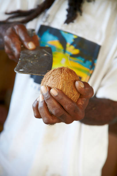istock Afro Caribbean Man Shelling Coconut 918776976