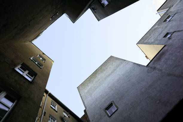 istock Look up at the multistory apartment house of angular shape. Empty place for text in the center. 918782282