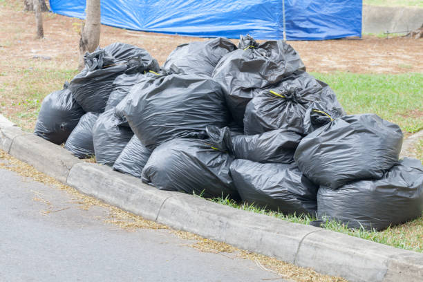 istock pile of black garbage bags in park 918783468