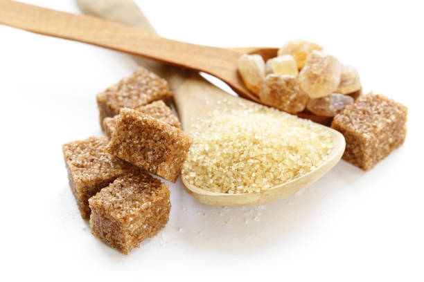 istock brown sugar sand and refined sugar on white background 918785786