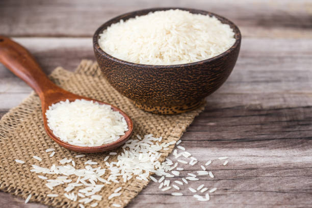 istock White Thai jasmine rice on wooden plank 918786788