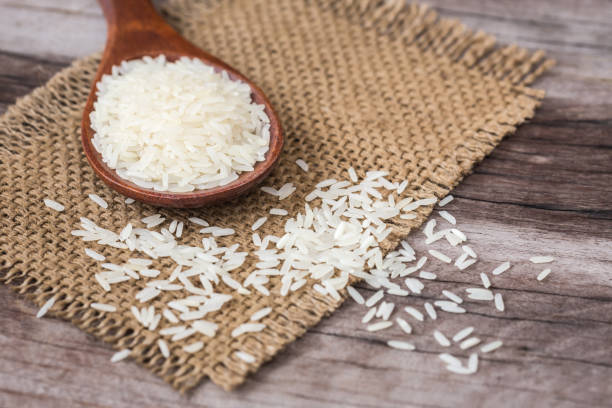 istock White Thai jasmine rice on wooden plank 918789122