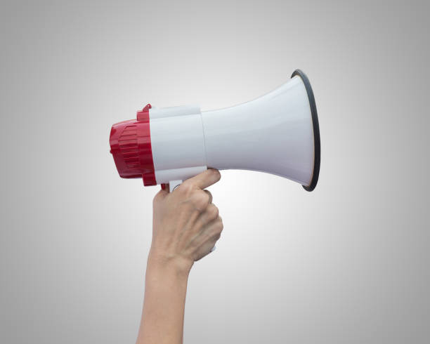 istock Hand holding white megaphone isolated on grey background. Saved with clipping path 918793006