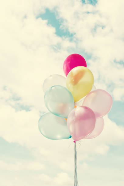 istock bunch of colored balloons with blue sky. 918807488