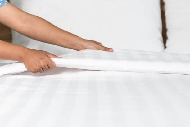 istock Hand set up white bed sheet in hotel room 918810516