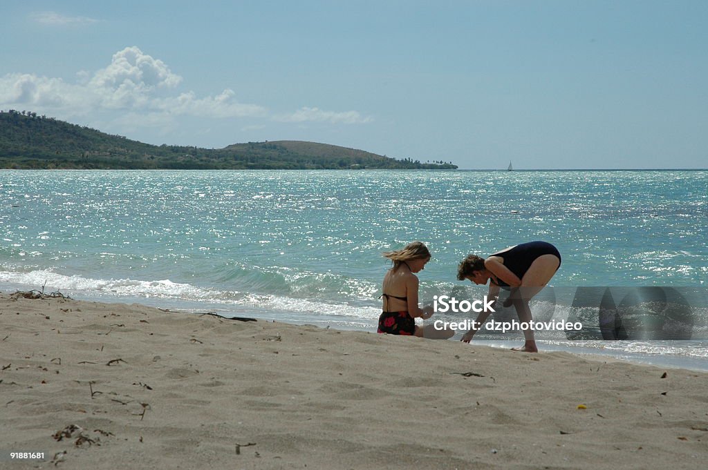 Two women relaxing on the beach  Adult Stock Photo