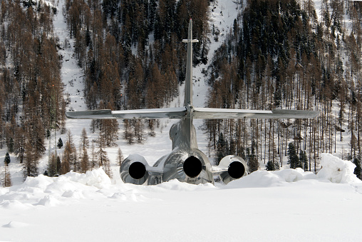 Rear view of silver color jet in the airport of in the alps switzerland in winter