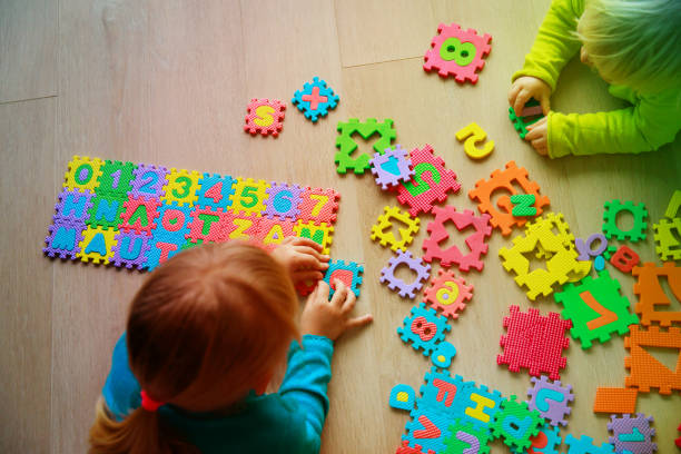 istock kids playing with puzzle, learning numbers and shapes 918821738