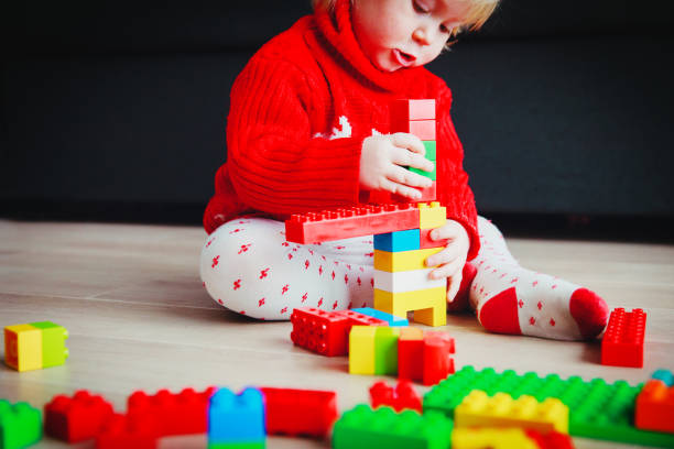 istock little baby playing with colorful plastic blocks 918821936