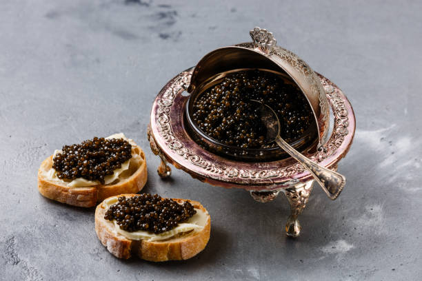 istock Black caviar in silver bowl and sandwiches 918824622