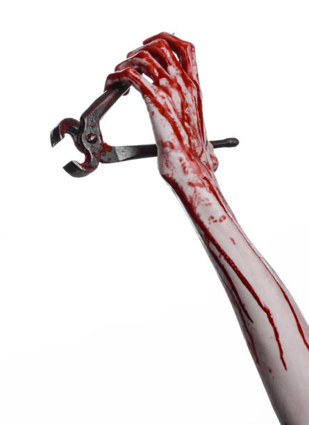 istock Halloween theme: bloody hand holding a pliers on a white background 918825906