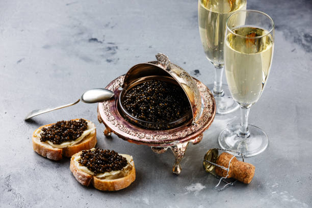 istock Black caviar in silver bowl, sandwiches and champagne 918831976