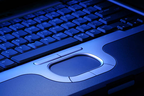 Laptop in blue light stock photo