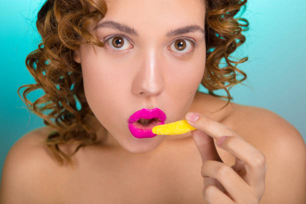 istock Beautiful girl with colored lipstick on lips. 918836090