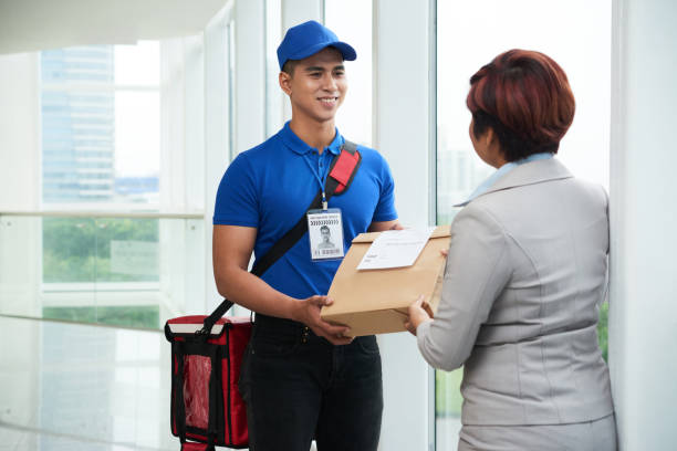 Bringing package to office Smiling Asian delivery man bringing package to business lady hot vietnamese women pictures stock pictures, royalty-free photos & images