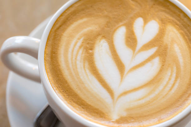 istock Hot Coffee latte art cappuccino White cup on Wooden table 918839364
