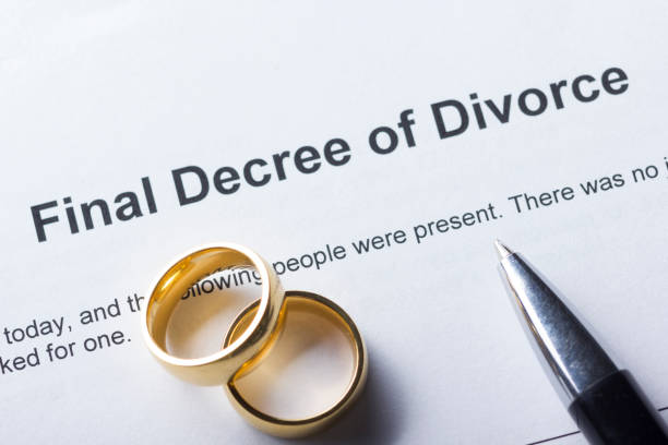 istock Divorce decree form with marriage ring and pen 918843568