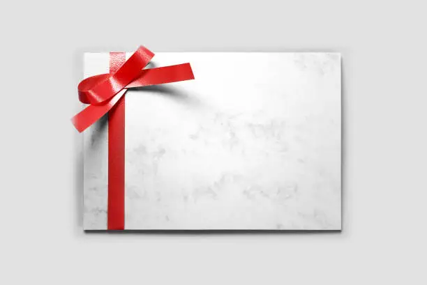 Blank thank you card decorated with red ribbon
