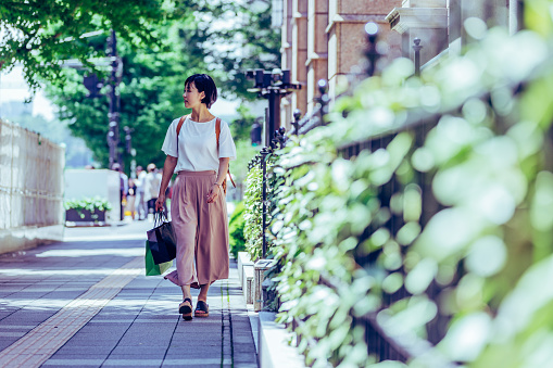 Japanese Girl wearing backpack exploring tourist locations in Tokyo, Japan