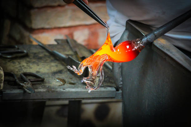 istock Glass Artist in her workshop making glassware 918861576