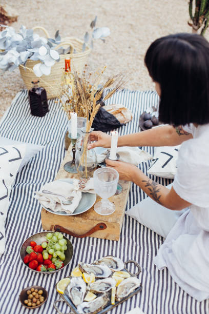 istock Woman arranges wedding picnic decorations 918865132