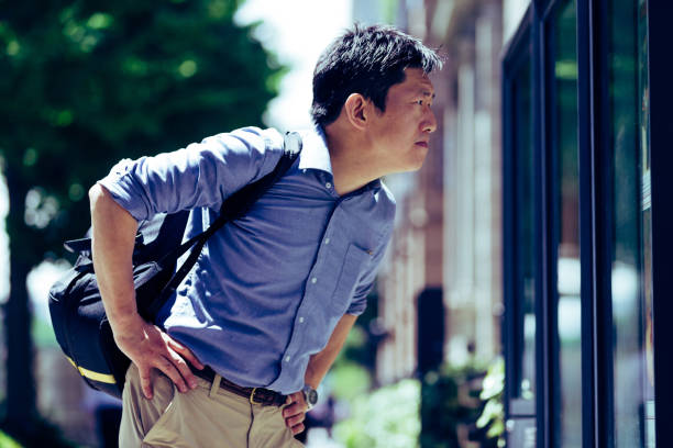 istock Japanese man holding a backpack checking the community notice board 918865152