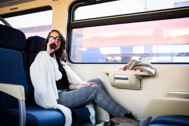 istock Young beautiful woman looking through the train window. 918865230