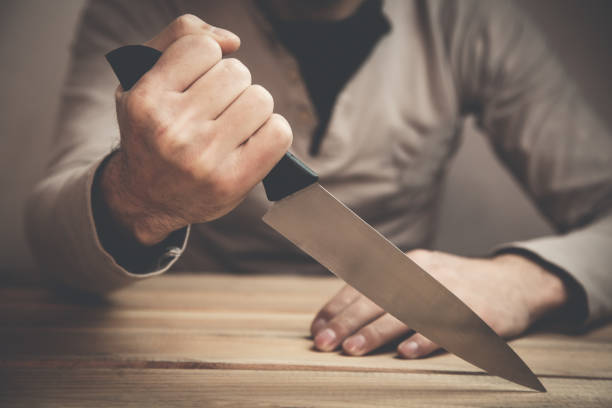 istock Caucasian criminal showing knife. 918865312