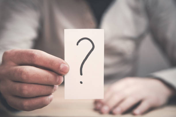 istock Man showing paper with question mark. 918865386
