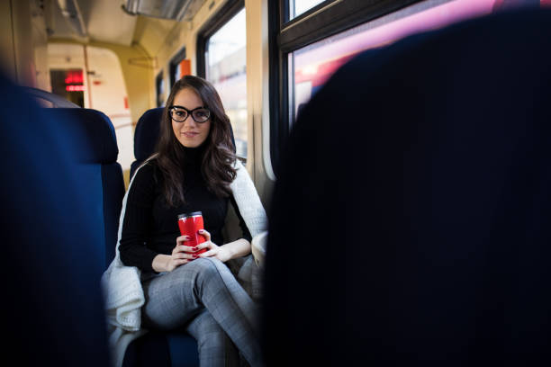 istock Young beautiful woman looking through the train window. 918868634
