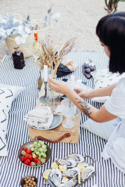istock Woman arranges wedding picnic decorations 918869674