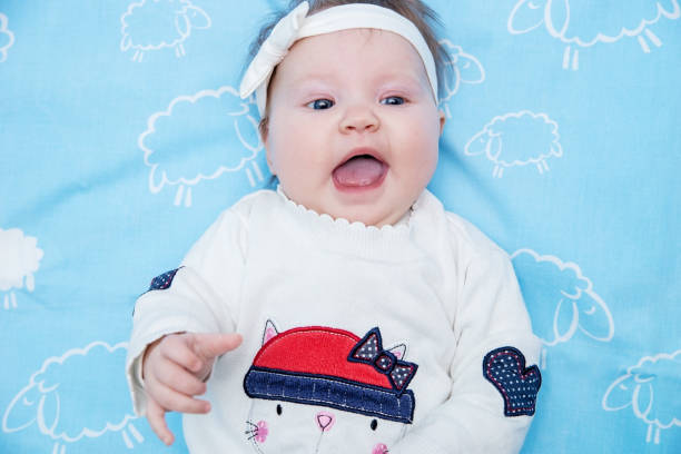 istock Little cute baby girl is lying on untouched, keep smiling. 918873232