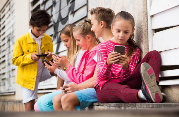 istock Five kids are playing on phone 918876190