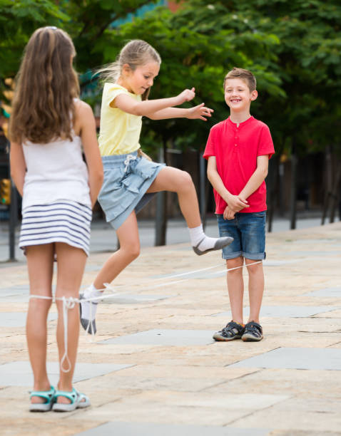 istock Kids playing with chinese jumping rope 918876264