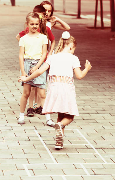 istock children skipping hopscotch 918876308