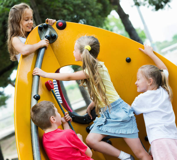 istock Kids  climbing together on playground's construction 918876354