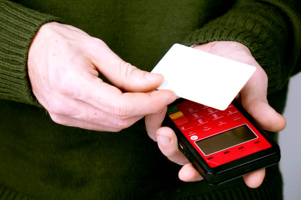 istock Close-up of a person using a credit card payment system 918876374