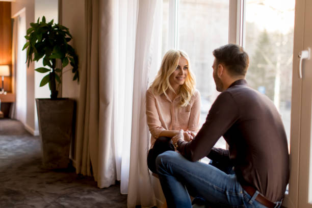 istock Loving couple by window in the room 918881156