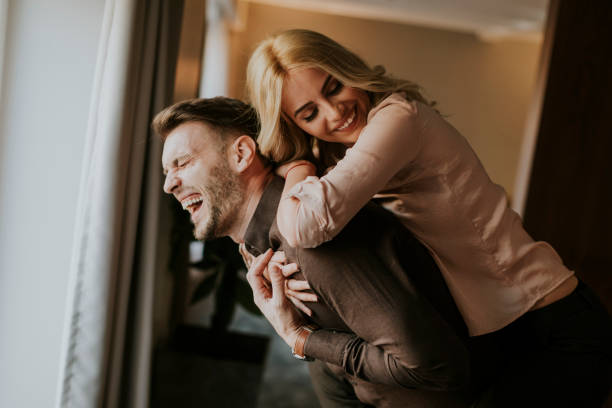 istock Young man carrying young woman on his back 918881184