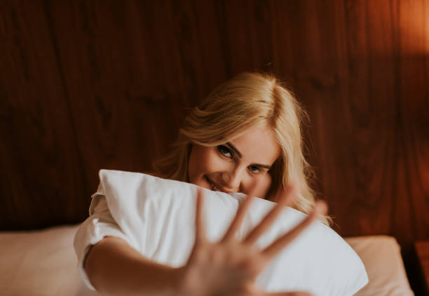 istock Young woman sitting on the bed 918881204