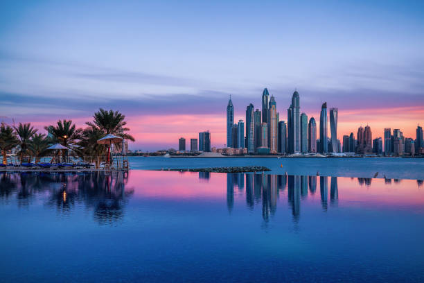 istock Skyline of Dubai Marina at a beautiful sunset with an infinity pool in front 918881304