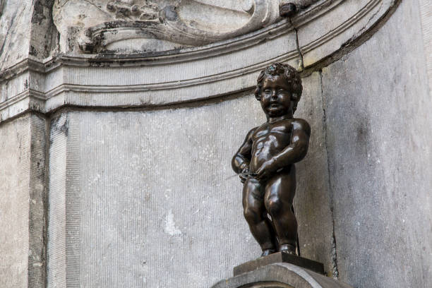 the famous statue of the picnic boy in Brussels, Belgium 06.26.2016. Editorial use only. a statue and a fountain in the center of the capital of Europe. manneken pis statue in brussels belgium stock pictures, royalty-free photos & images