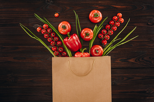 top view of different red vegetables in shopping bag, grocery concept