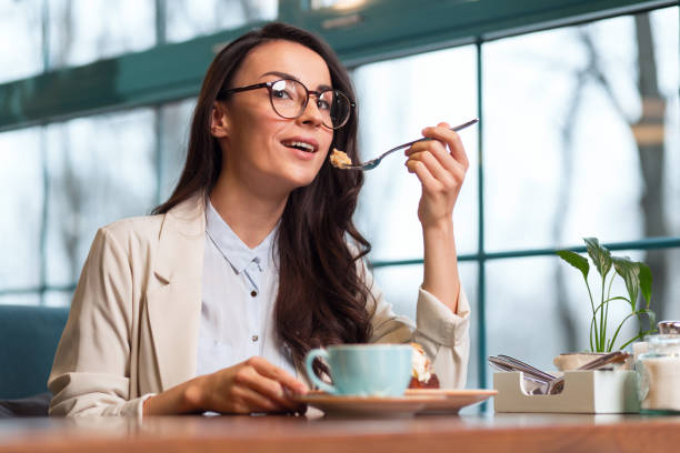 istock Wistful elegant woman eating desert 918881578