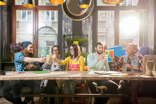 istock Friends clinking glasses in the modern cafe 918881826
