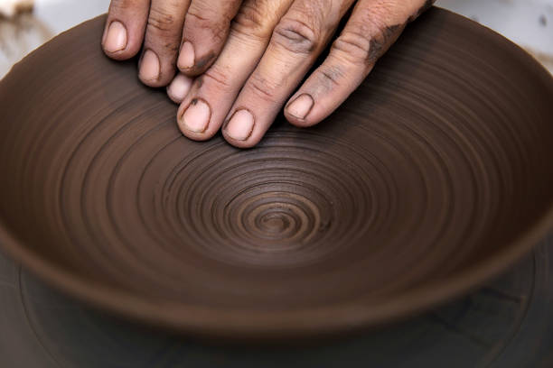 istock Artist makes clay pottery on a spin wheel 918882304