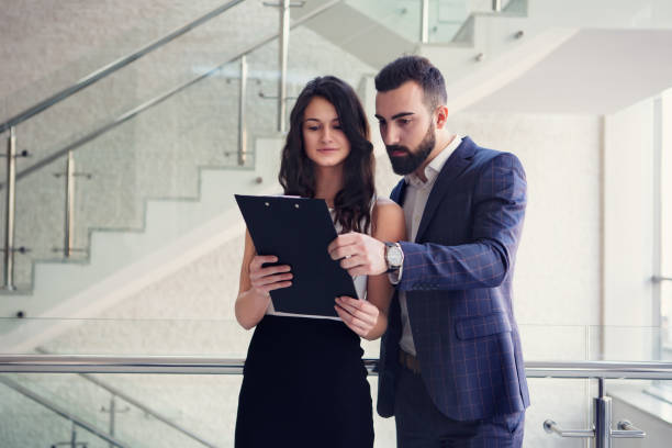 istock Two business colleagues talk about work outside office. 918885712