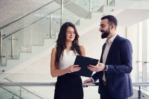 istock Two business colleagues talk about work outside office. 918886172