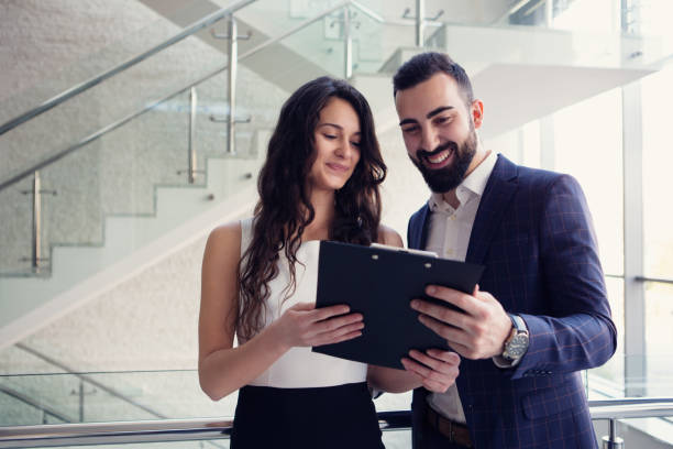 istock Two business colleagues talk about work outside office. 918886684