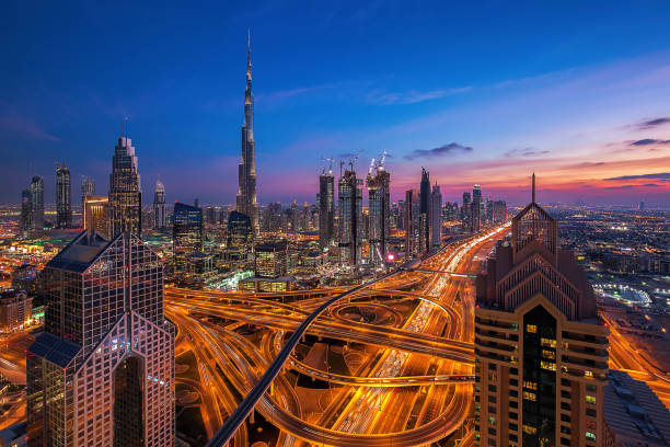 Dubai skyline at sunset Dubai skyline at sunset khalifa stock pictures, royalty-free photos & images